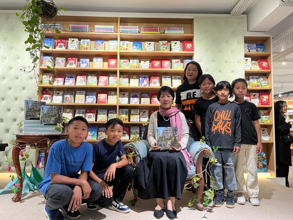 Easterine Kire poses along her newest book titled, ‘Molly &Froggo the Frog’ launched at the White Owl on February 19. (Morung Photo)